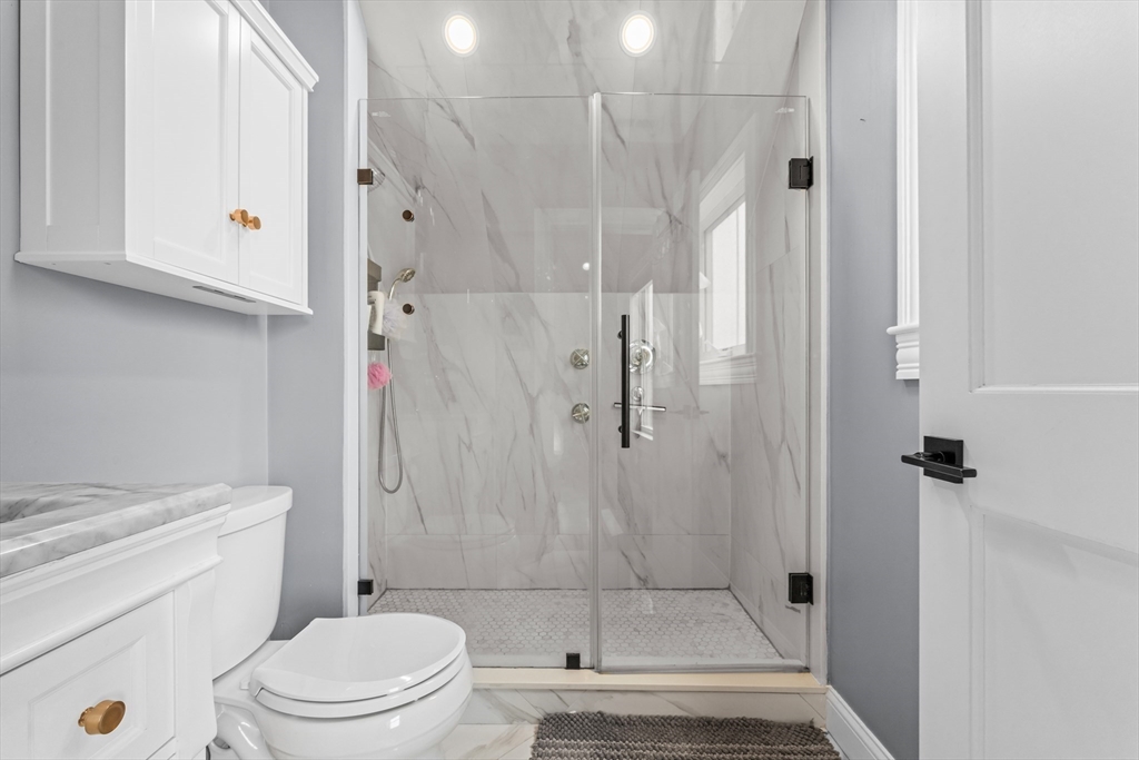 28 Dix Street, Unit 3 Boston, MA 02122 - Photo 22 of 34 a bathroom with a shower a toilet and a sink