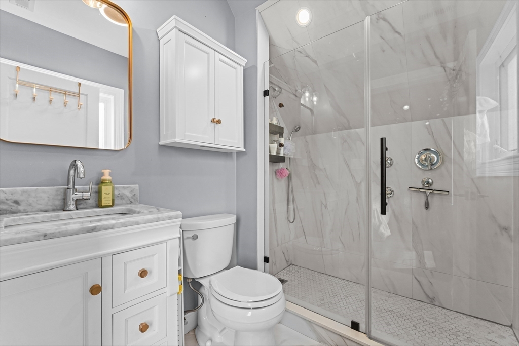 28 Dix Street, Unit 3 Boston, MA 02122 - Photo 23 of 34 a bathroom with a granite countertop sink toilet and shower