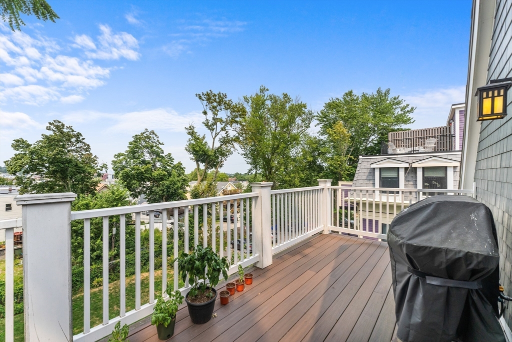 28 Dix Street, Unit 3 Boston, MA 02122 - Photo 26 of 34 a balcony with wooden floor and fence
