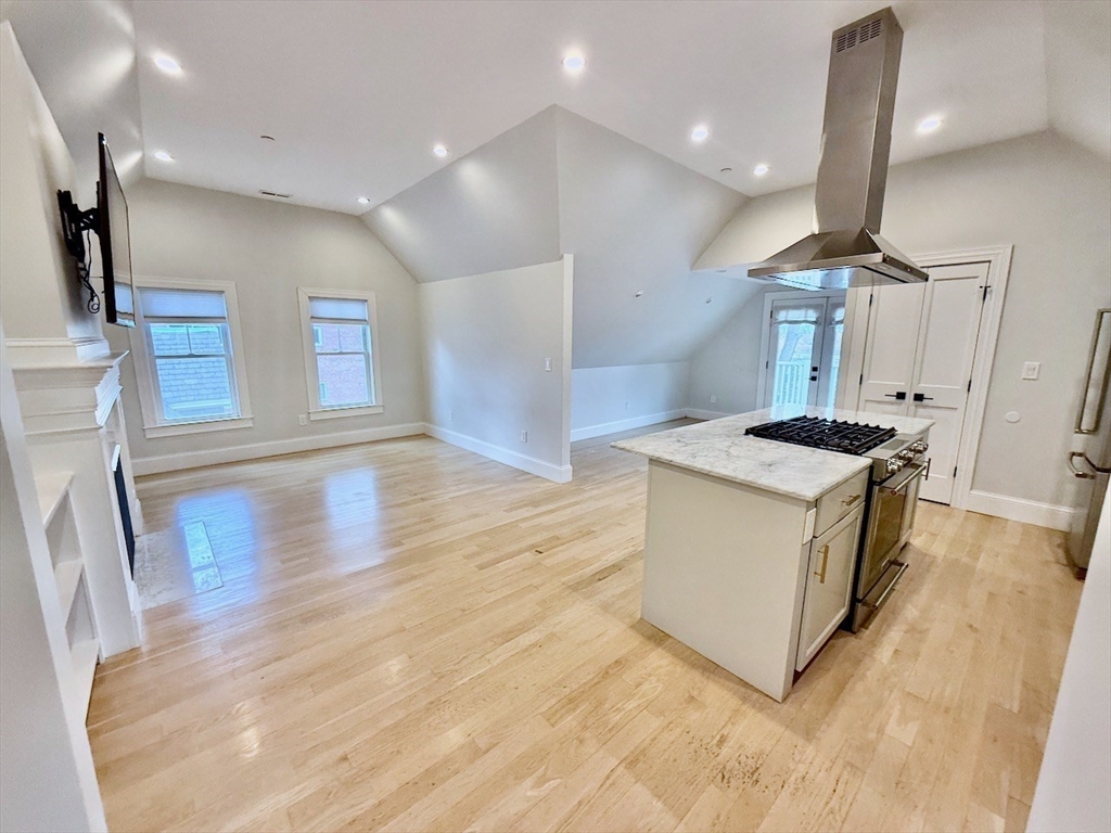 28 Dix Street, Unit 3 Boston, MA 02122 - Photo 6 of 34 a kitchen with stainless steel appliances granite countertop a sink a stove and a wooden floors
