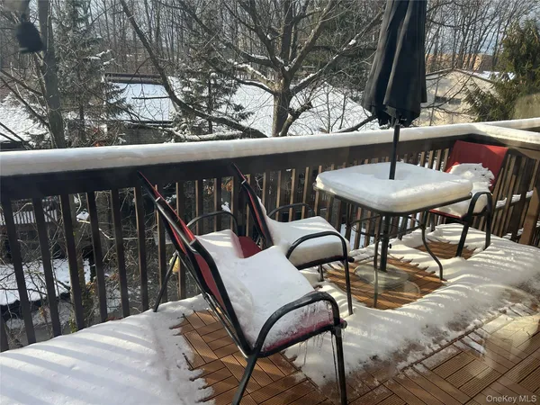 a balcony with table and chairs