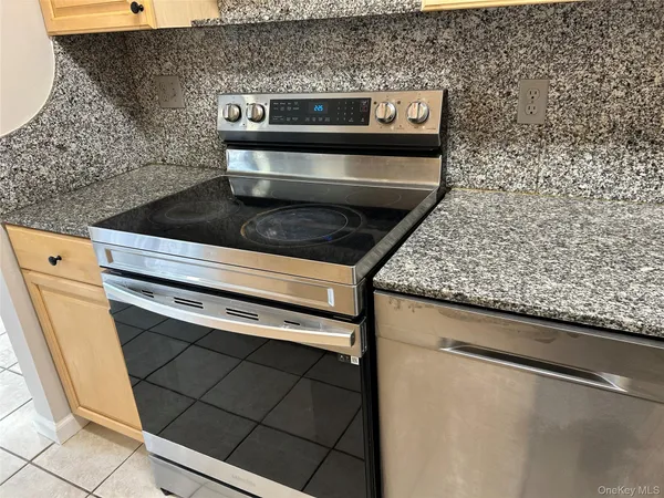 a stove top oven sitting inside of a kitchen