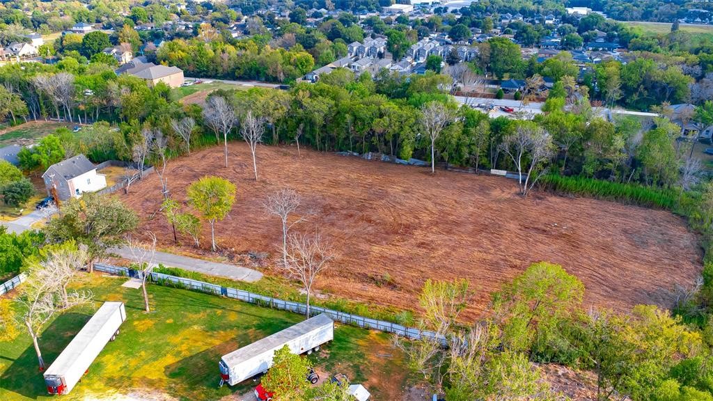 8888 Freeland Street Houston, TX 77075 - Photo 3 of 12 an aerial view of a house with a yard and lake view