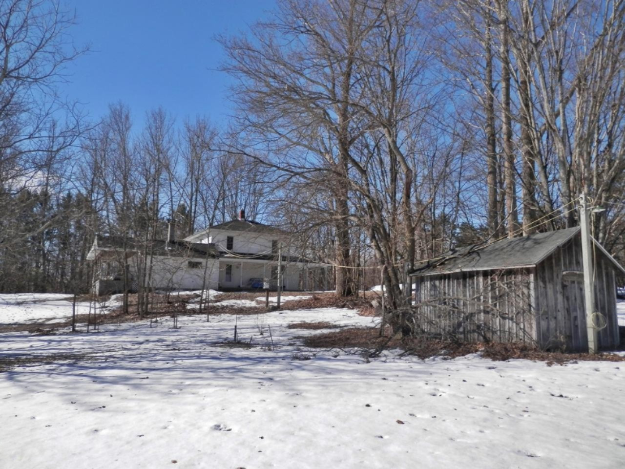 8790 Ruttan Road Northwest Alden, MI 49612 - Photo 41 of 43 Side view of home with storage building