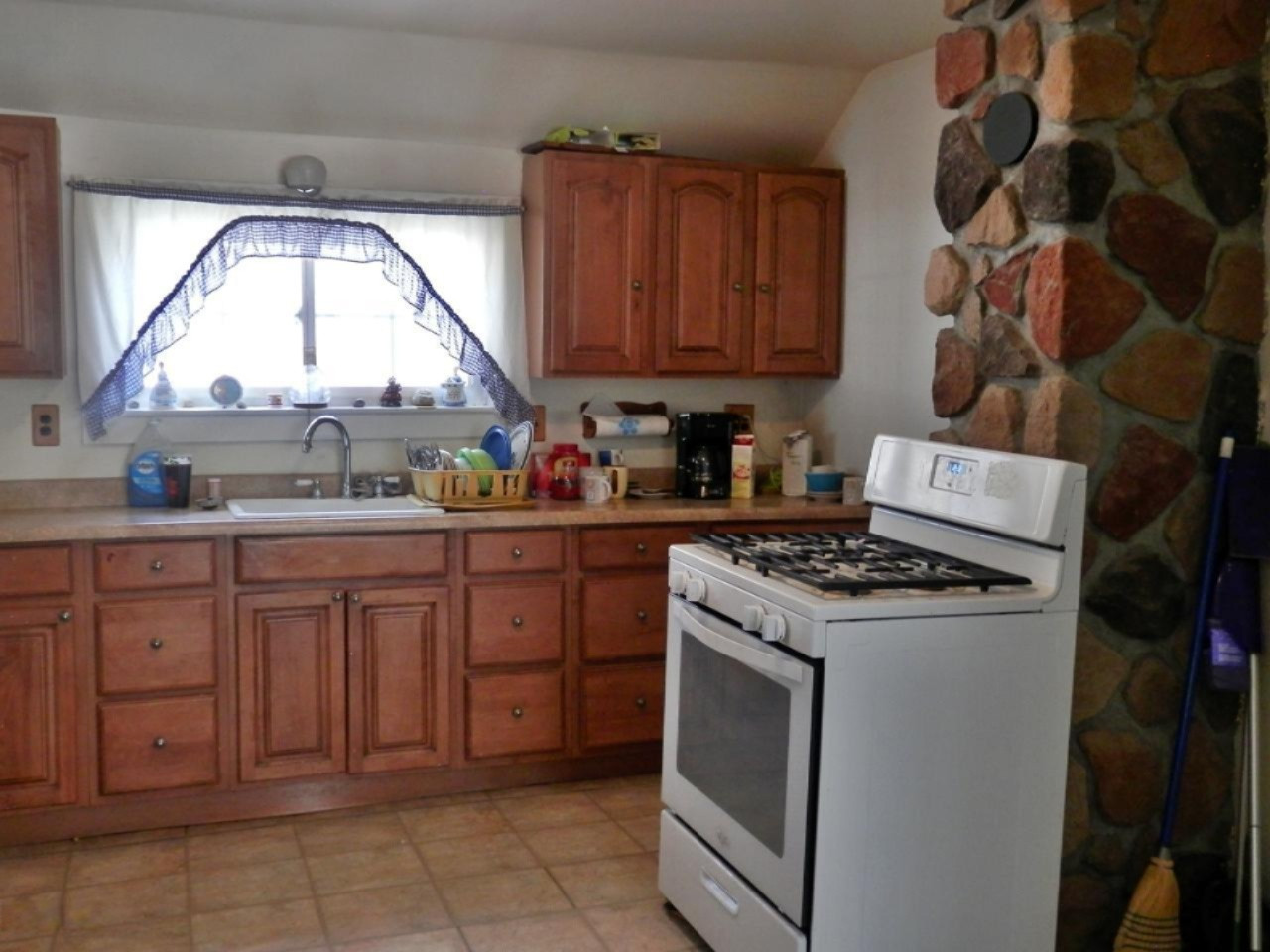 8790 Ruttan Road Northwest Alden, MI 49612 - Photo 8 of 43 Oak kitchen with stone accent