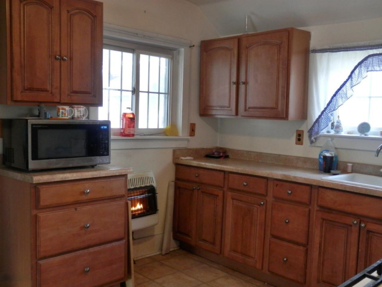 8790 Ruttan Road Northwest Alden, MI 49612 - Photo 9 of 43 Gas wall heater in kitchen