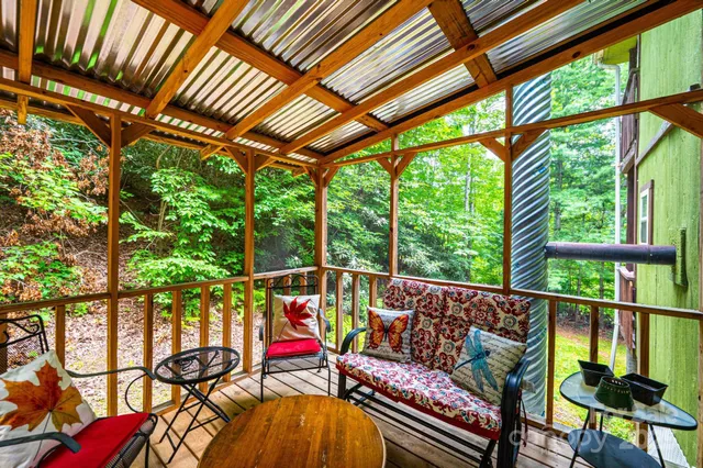 a balcony with furniture and wooden floor