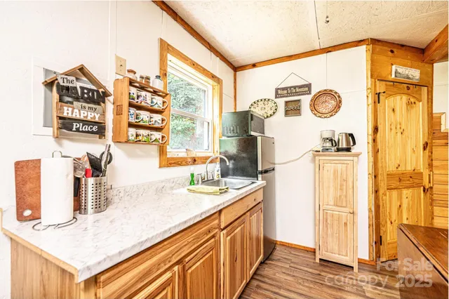 a kitchen with stainless steel appliances granite countertop a sink and a refrigerator