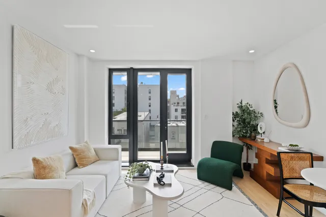 a living room with furniture a kitchen island a dining table and a sink