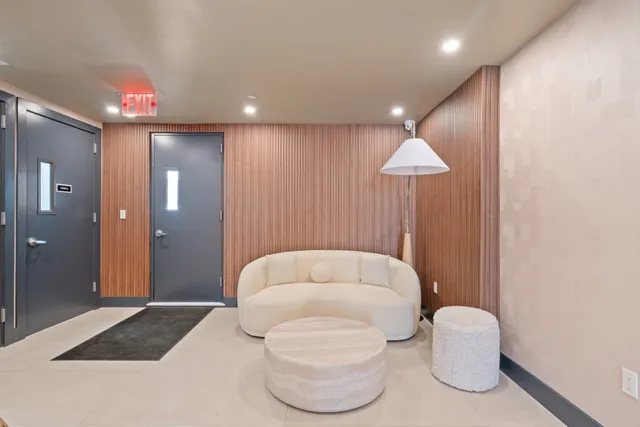 a view of a roof deck with couches and potted plants