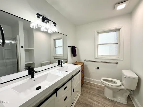 a bathroom with a sink a toilet and mirror