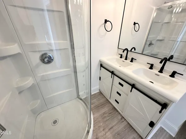 a bathroom with a double vanity sink and mirror