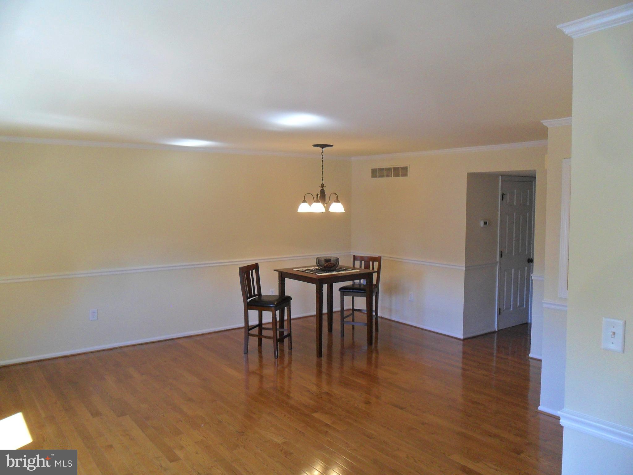 9 Delaware Street, Unit 9 New Castle, DE 19720 - Photo 22 of 28 a dining room with furniture and wooden floor