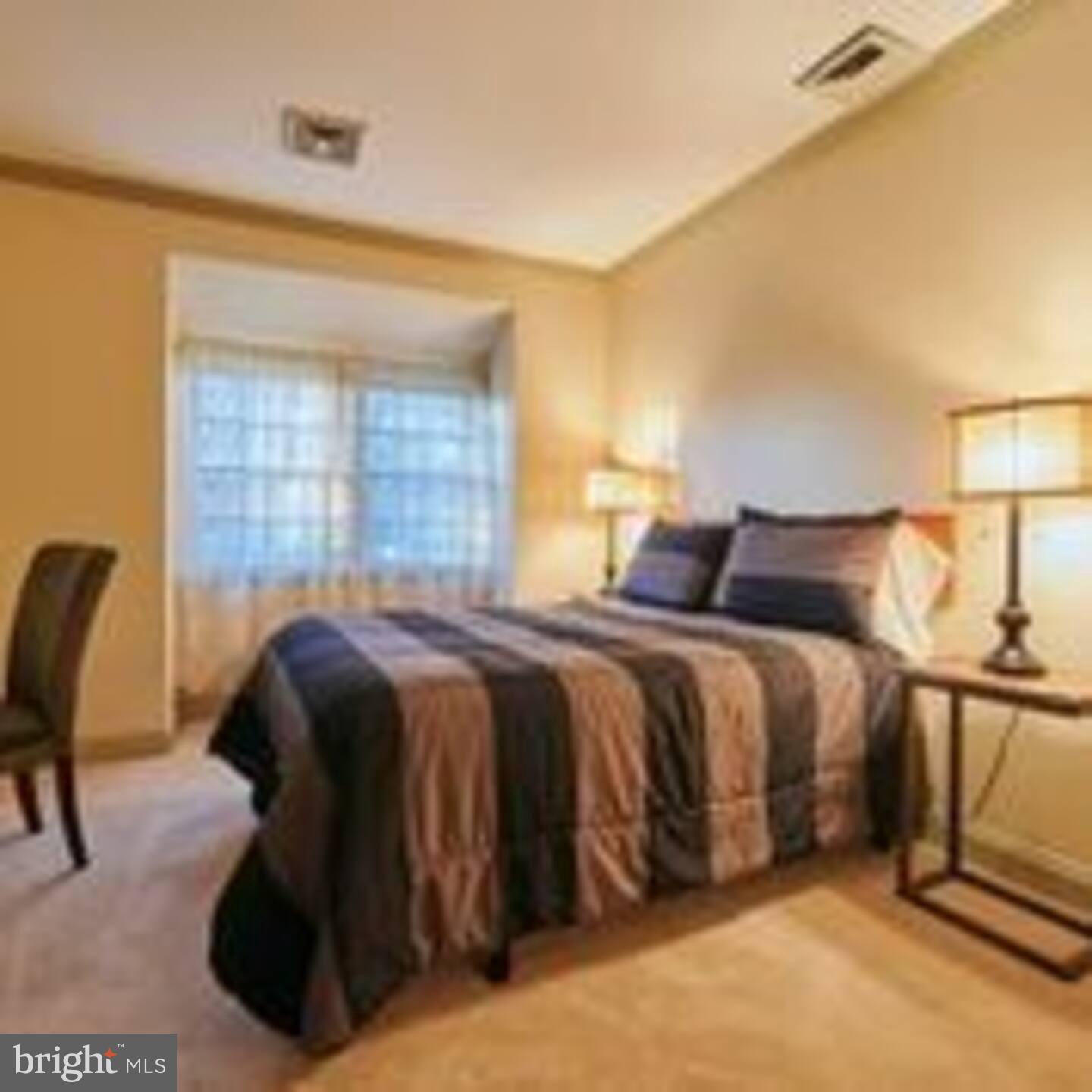 9 Delaware Street, Unit 9 New Castle, DE 19720 - Photo 28 of 28 a bedroom with a bed and a chair