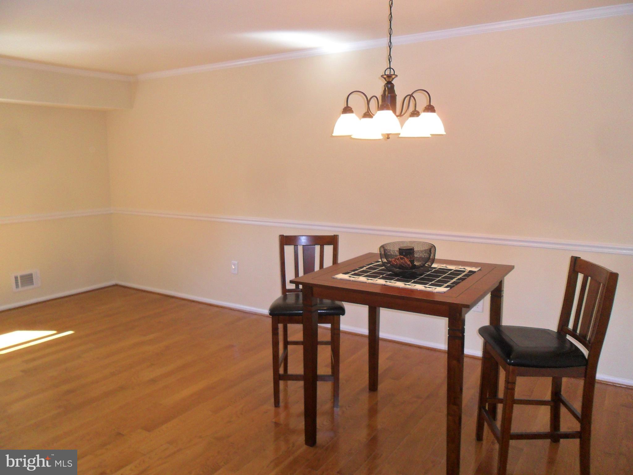 9 Delaware Street, Unit 9 New Castle, DE 19720 - Photo 4 of 28 a view of a dining room with furniture and wooden floor