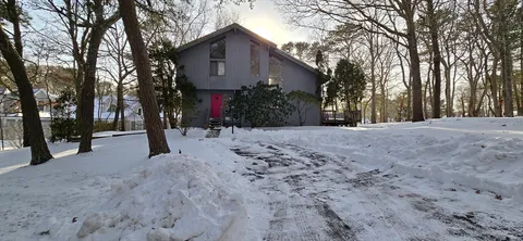 a view of a house with a snow in the yard