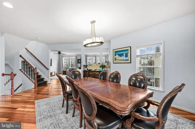 a large kitchen with kitchen island a large counter top stainless steel appliances and cabinets