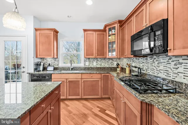 a kitchen with granite countertop a stove and a sink