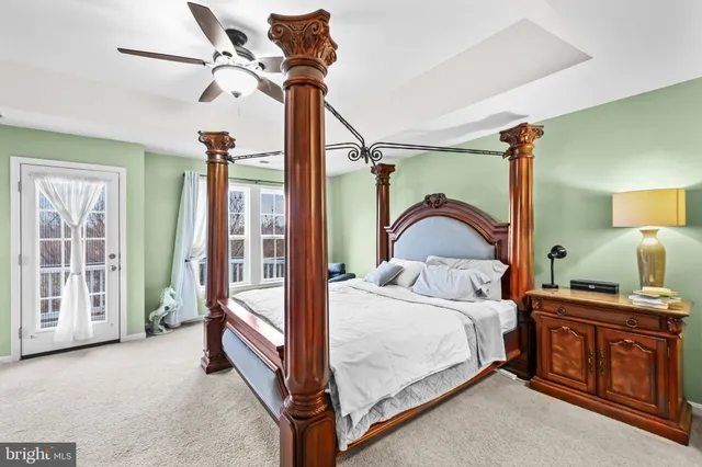 a bedroom with a bed dresser and a flat tv screen