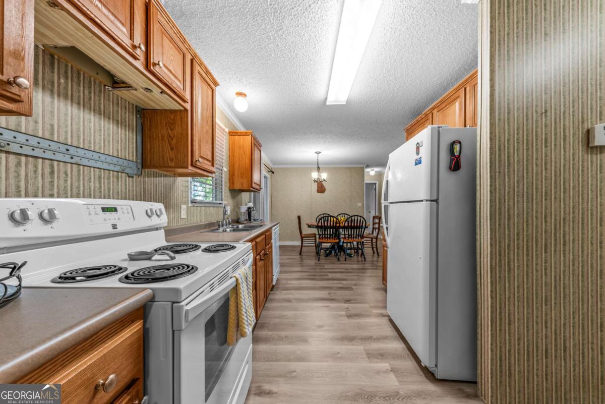 194 Phillips Road Eatonton, GA 31024 - Photo 10 of 57 a kitchen with stainless steel appliances a stove a sink and a refrigerator