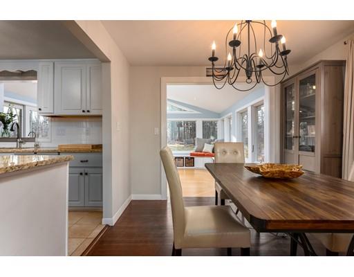 73 Woobly Road Bolton, MA 01740 - Photo 6 of 30 a kitchen with stainless steel appliances granite countertop a sink dishwasher a stove a dining table and chairs with wooden floor