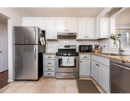 73 Woobly Road Bolton, MA 01740 - Photo 7 of 30 a kitchen with white cabinets and stainless steel appliances