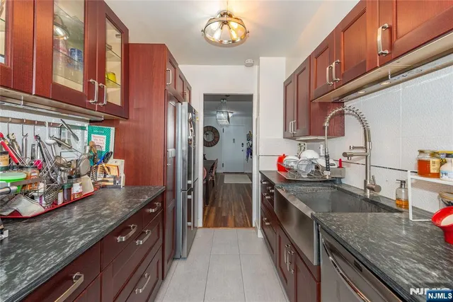 a kitchen with stainless steel appliances granite countertop a stove a sink and a counter space