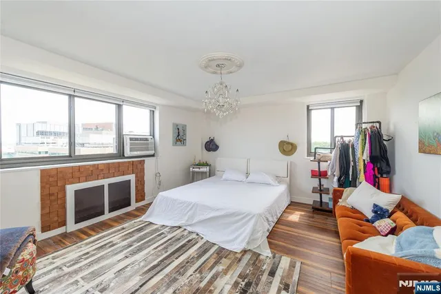 a bedroom with bed and wooden floor