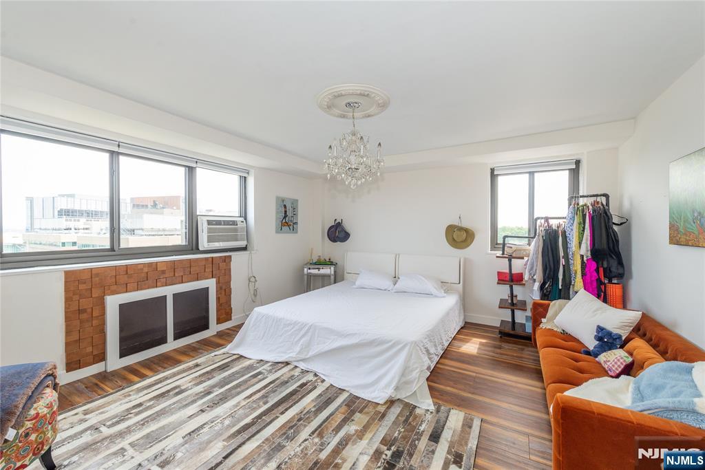 90 Prospect Avenue, Unit 10A Hackensack, NJ 07601 - Photo 14 of 35 a bedroom with bed and wooden floor