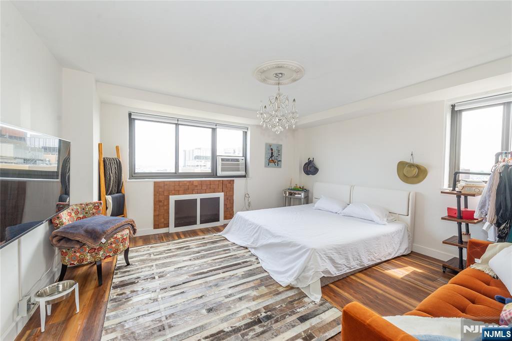 90 Prospect Avenue, Unit 10A Hackensack, NJ 07601 - Photo 15 of 35 a bedroom with a bed and a fireplace