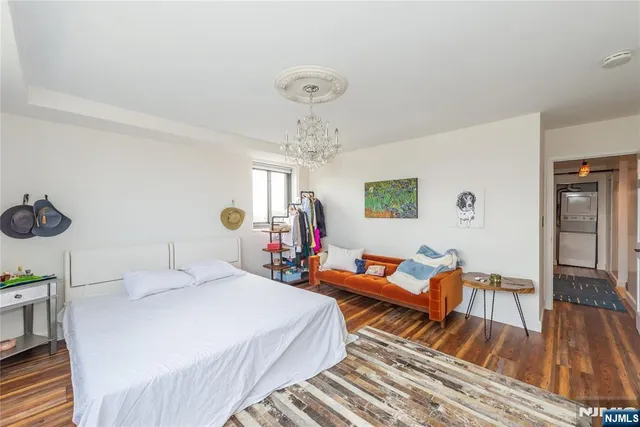 a bedroom with furniture and a chandelier