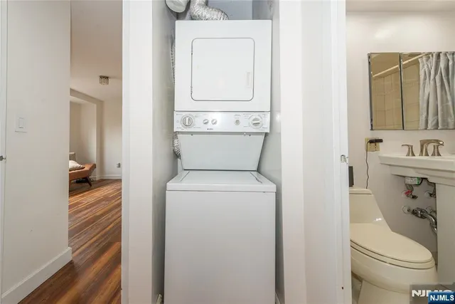 a bathroom with a shower a sink and mirror