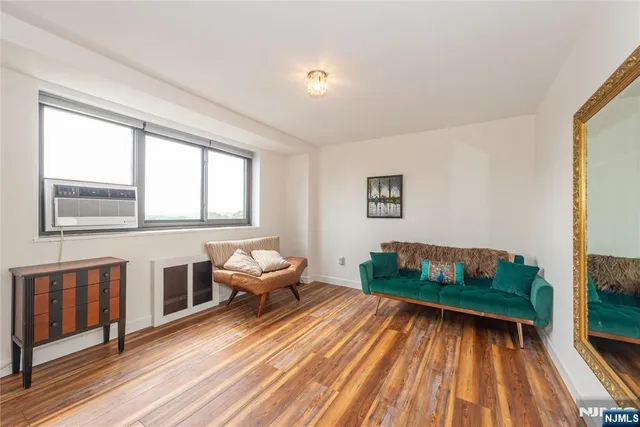 a view of a bedroom with wooden floor and closet
