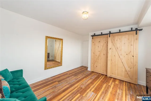 a bedroom with a bed and a couch with window