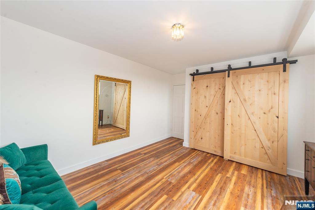 90 Prospect Avenue, Unit 10A Hackensack, NJ 07601 - Photo 25 of 35 a view of a bedroom with wooden floor and closet