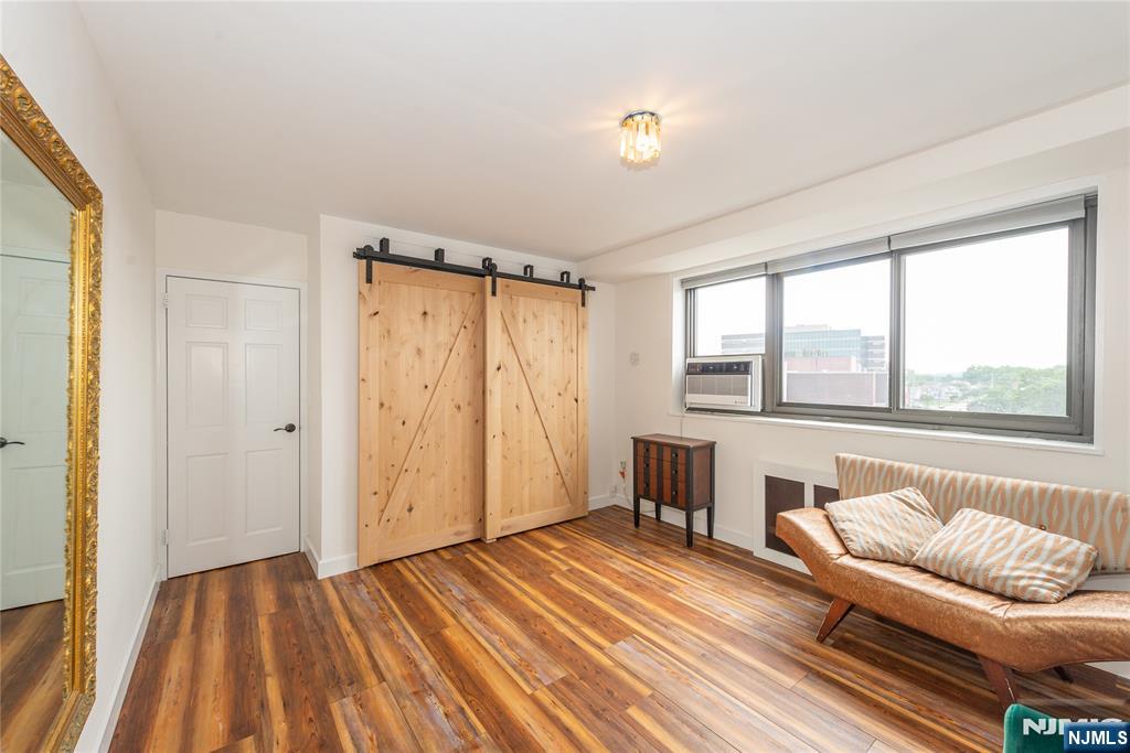 90 Prospect Avenue, Unit 10A Hackensack, NJ 07601 - Photo 26 of 35 a bedroom with a bed and a couch with window