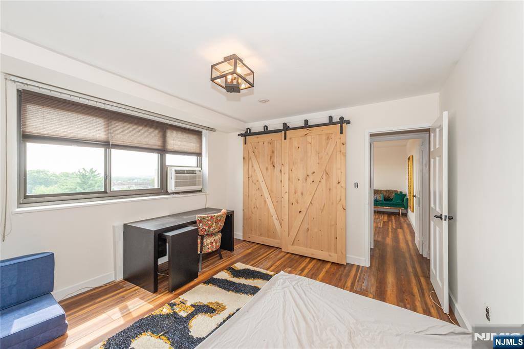 90 Prospect Avenue, Unit 10A Hackensack, NJ 07601 - Photo 28 of 35 a bedroom with a bed and a window