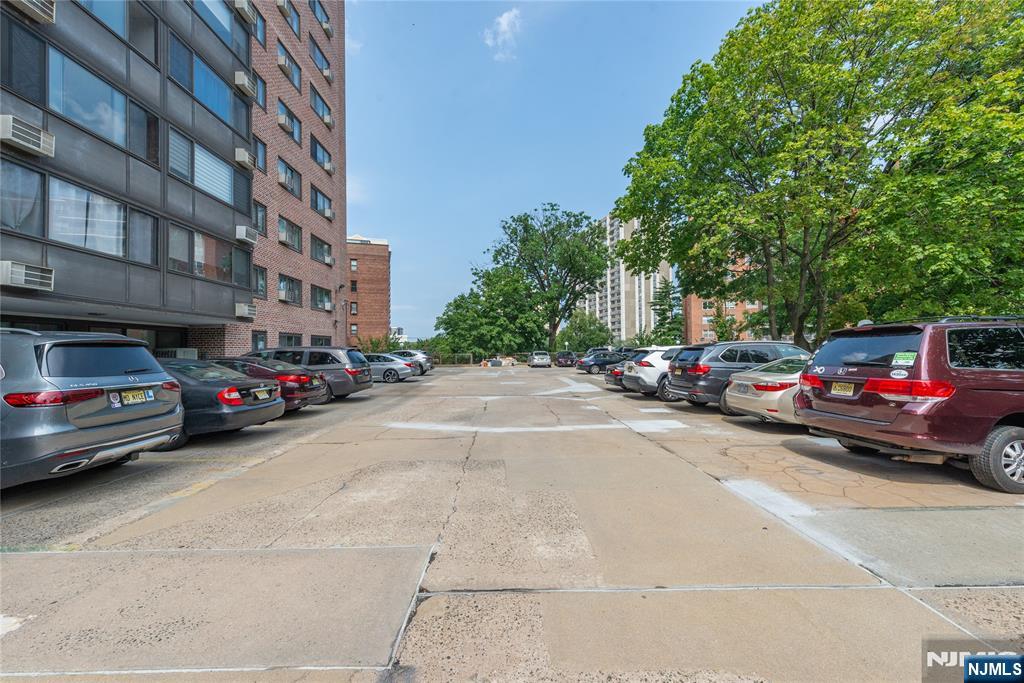 90 Prospect Avenue, Unit 10A Hackensack, NJ 07601 - Photo 34 of 35 a view of road with card parked on road and trees