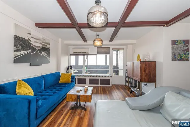 a living room with furniture fireplace and wooden floor