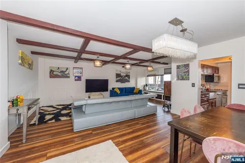 a living room with furniture and a chandelier