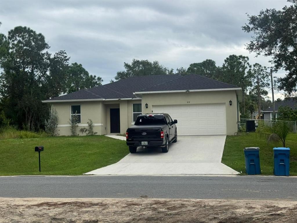607 Reading Street Southeast Palm Bay, FL 32909 - Photo 8 of 10 a car parked in front of a house