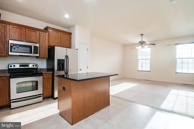 a kitchen with stainless steel appliances a stove a microwave and sink