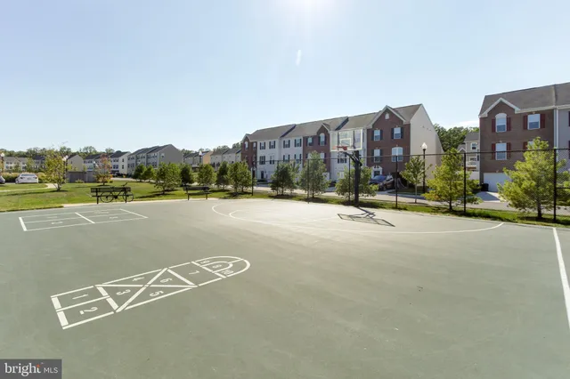 a view of a swimming pool with a bench in patio