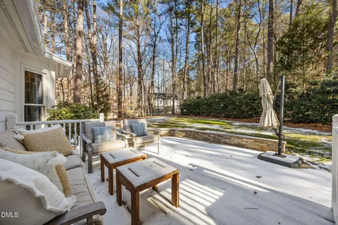 a view of house with wooden door and potted plants