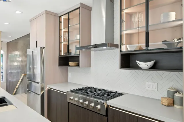 a kitchen with stainless steel appliances a sink a stove and a refrigerator