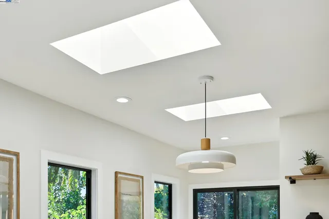 a spacious bathroom with a double vanity sink toilet mirror and bathtub