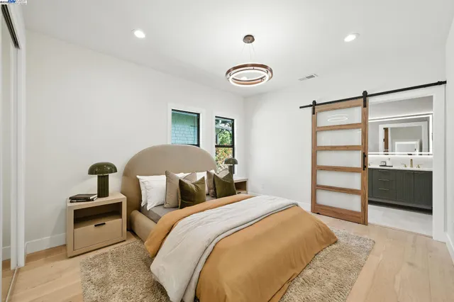 a bedroom with bed and glass door