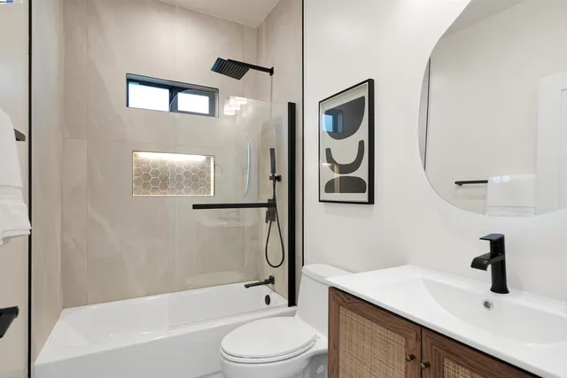 a room with painting on the wall and a window