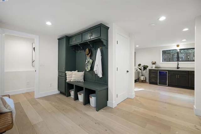 a view of a hallway with wooden floor and windows