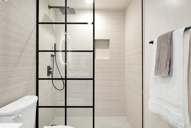 a view of a patio with couches table and chairs and wooden floor